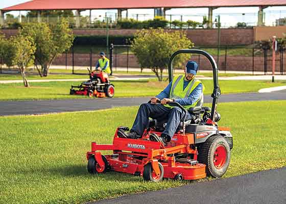 Men mowing with commercial mowers