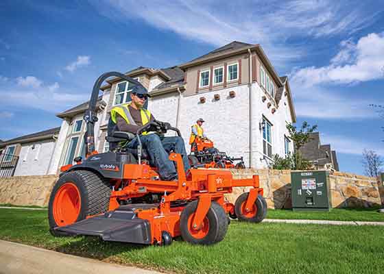 Men mowing with commercial mowers