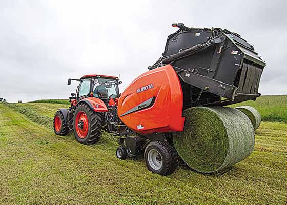 Kubota tractor pulling hay baler