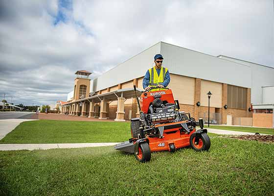 Landscaping company cutting with mower