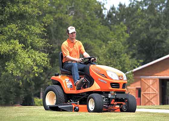 Man on Kubota Riding Mower Cutting Grass