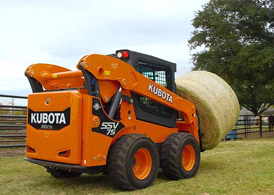 Kubota skid steer with hay bale